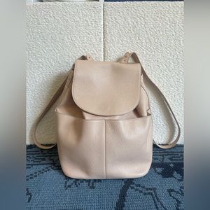 Cuyana Italian leather backpack with gold hardware in a blush pink nude/cream
